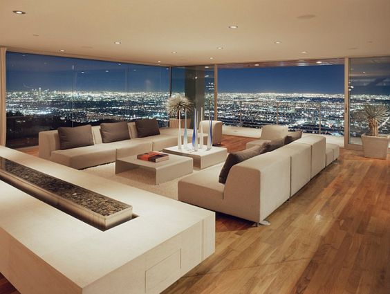 Keeping furniture low and horizontal will increase the perceived height of your room. It'll also accentuate any views. Even if you're not living in a penthouse with views like this, it will still make your ceiling appear higher.
