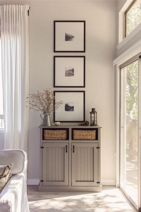 A vertical display of pictures or objects will guide your eye upwards and give the illusion of more headroom.