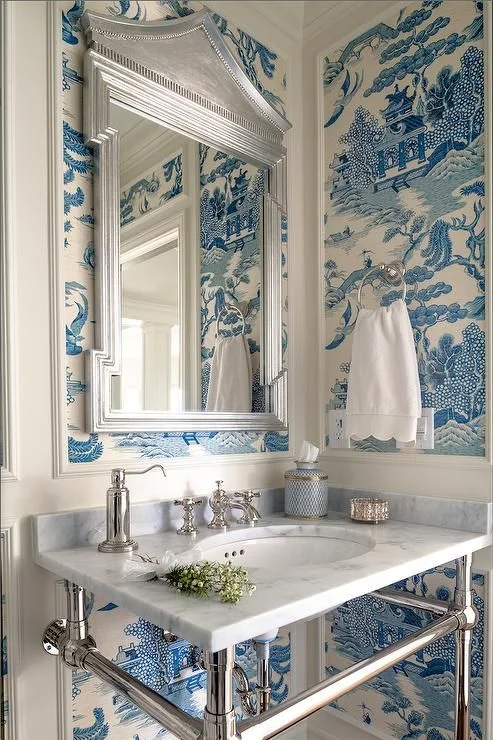 Get the oriental look in your own home by choosing a bold chinoiserie wallpaper. The timeless blue and white colour scheme here looks elegant with the marble sink and silvered shiny accessories.