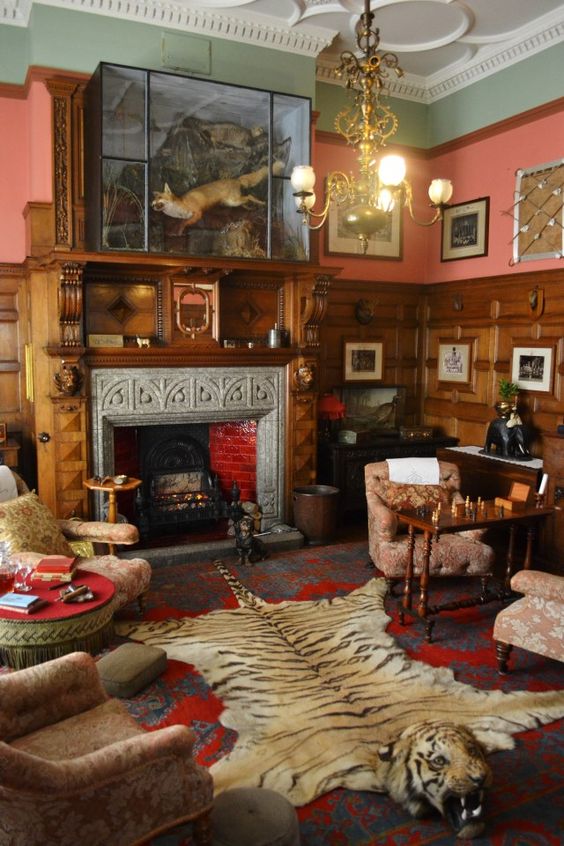 The smoking room at Lanhydrock in Cornwall is a striking room - not least because of the tiger skin rug and taxidermy fox. However, it also uses two quite contrasting colours together - the sage green at the top of the room, with a more vibrant red pink underneath. David Ramsey Hay, a decorative artist and writer had two theories about decorating, one of which was 'harmony by contrast' - using together two colours on the opposite side of the colour wheel. This is a good example! 