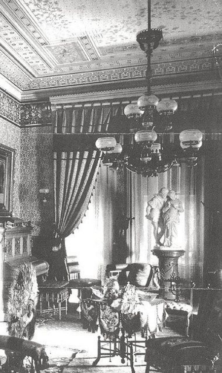 The classical statues above are the main focal point of this Victorian room. 
