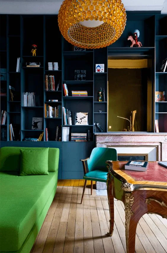 Another example of how well bright green can look against a dark teal backdrop. Break the blocks of colour up with wood, white and flashes of warm tonal colours - here the orange light and red on the desk. Picture: networkveka.co.uk