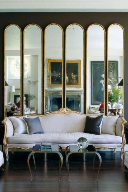 A line of the same mirrors placed next to each other create a fragmented reflection which really stands out against the dark walls. A very elegant and modern idea that enhances this traditional and classic room. Image: houseandgarden.co.uk