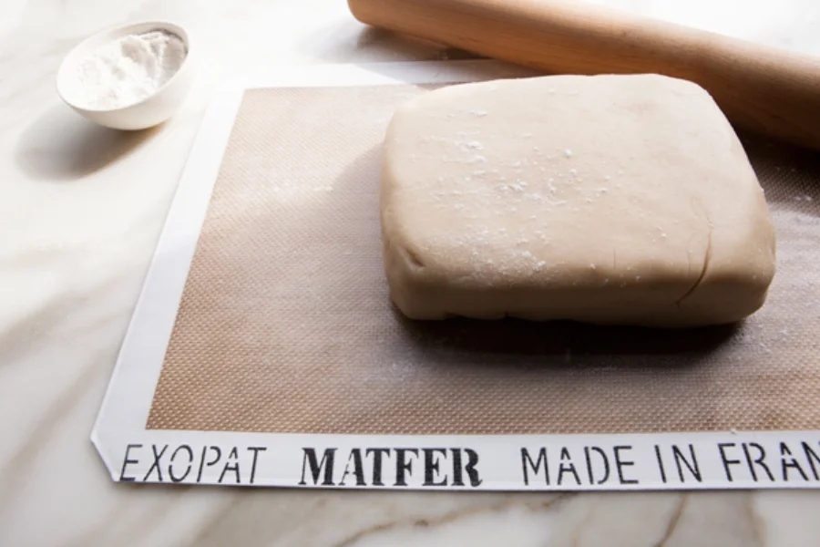 Forming the dough into a rectangular shape. Give the dough a light dusting of flour to prevent the rolling pin from sticking.