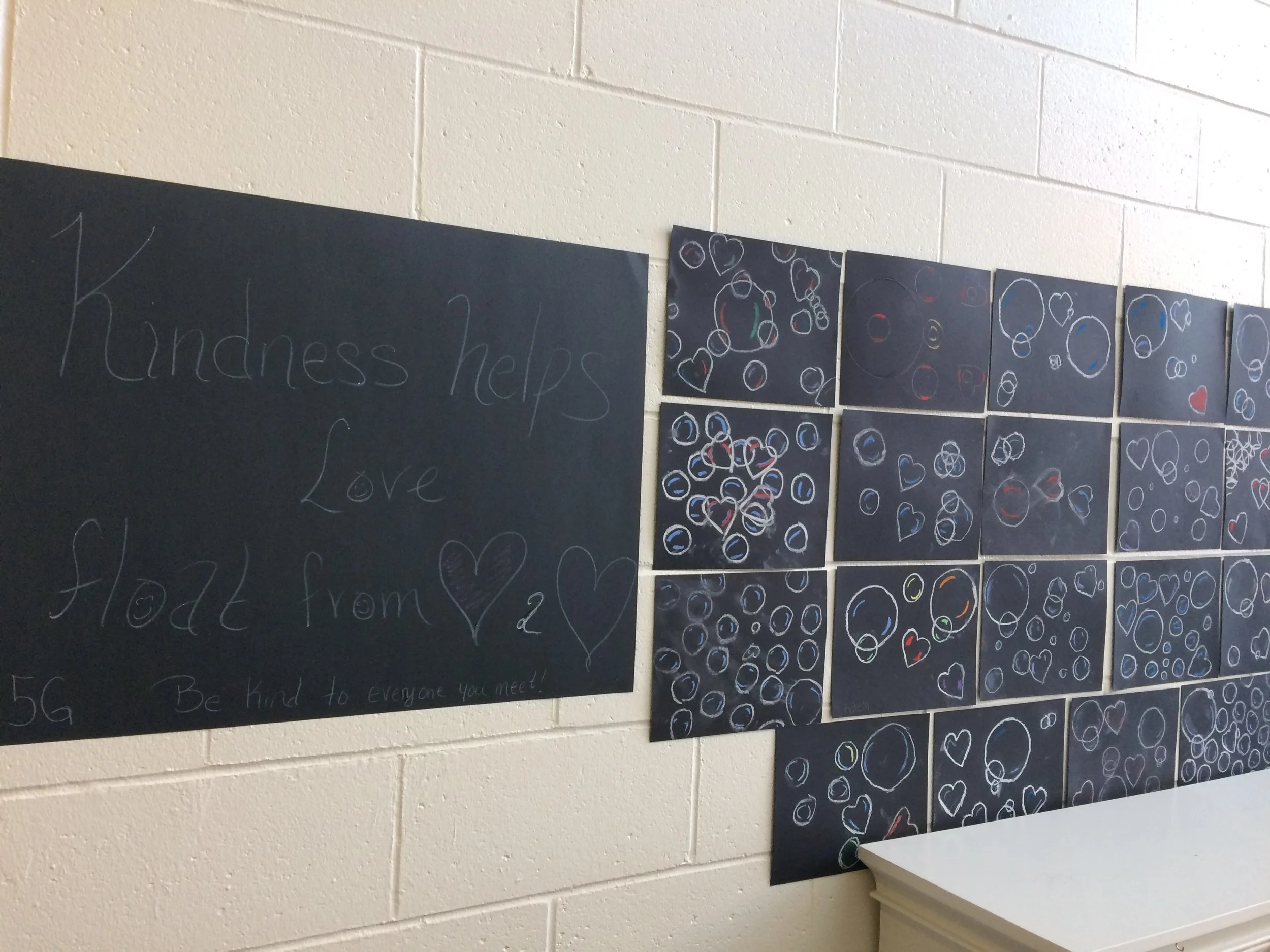 Random Acts of Kindness. Mme Mireille's class created a kindness campaign in our school. This was to bring awareness to mental illness and how a small act can make a big difference in someone's day and life. The students left positive notes around the school and carried out other acts that put smiles on many faces! The picture is of the mural the class created "Kindness helps Love Float" A small act of kindness can make a big difference!