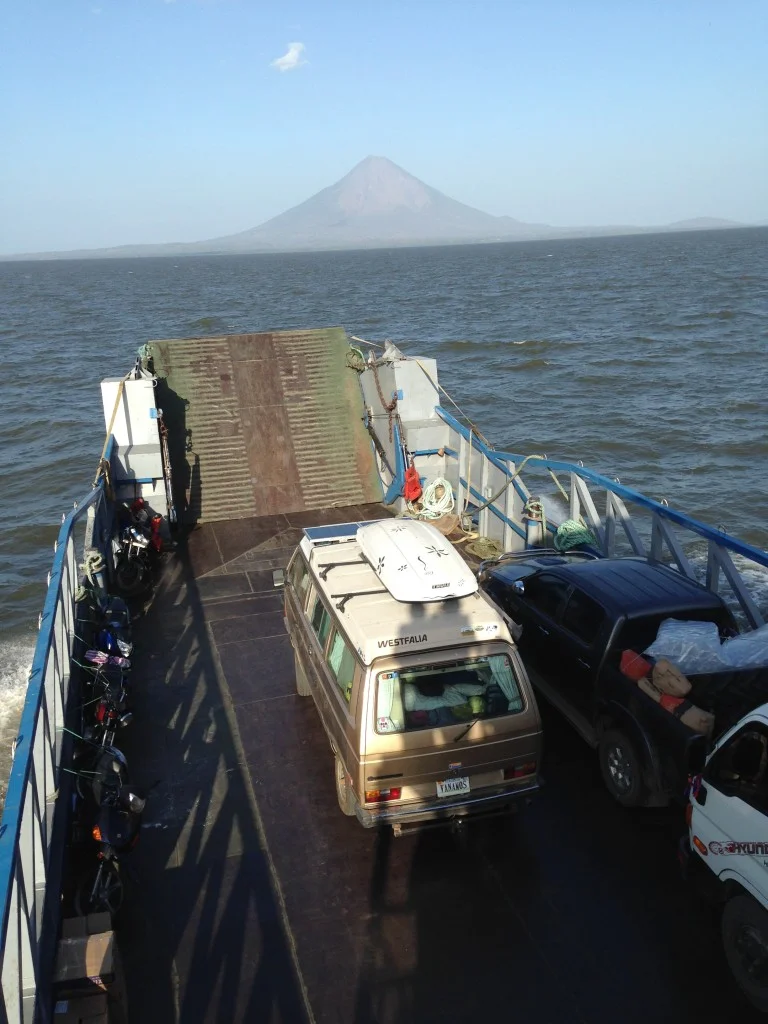 Crossing Lake Nicaragua on the way to Isla de Ometepe with Vulcan Concepcion looming in the background. The people shadows that you see on the back of Wesley are Coconut and me.