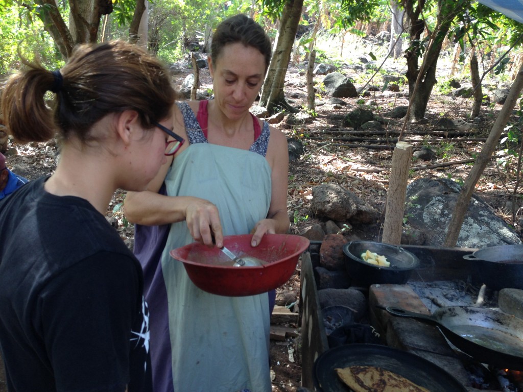 Maria and Coconut making breakfast pancakes on the open fire.