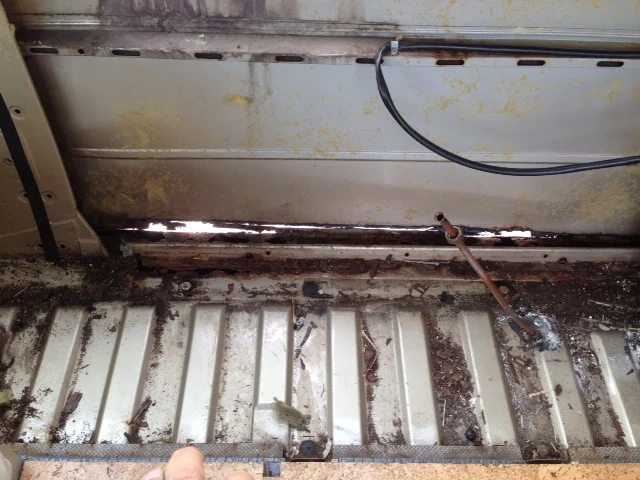 The main reason we needed to take out the cabinets is so that this rusty panel could be replaced.