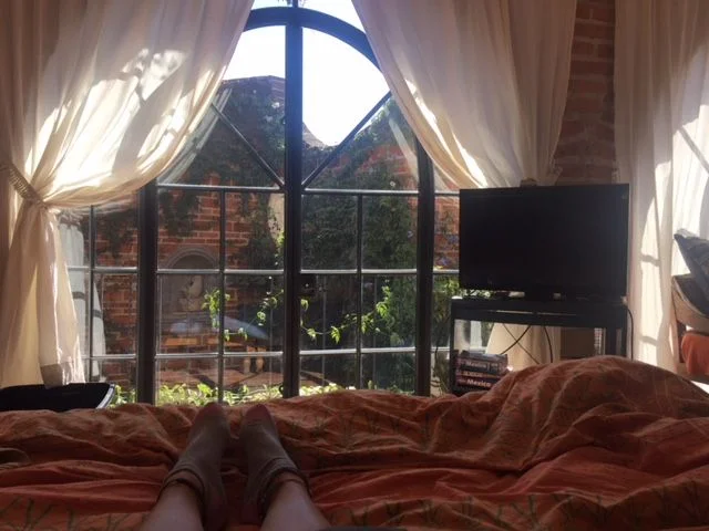 The view from the second floor master bedroom is through three arched glass doors into our plant filled interior courtyard. 