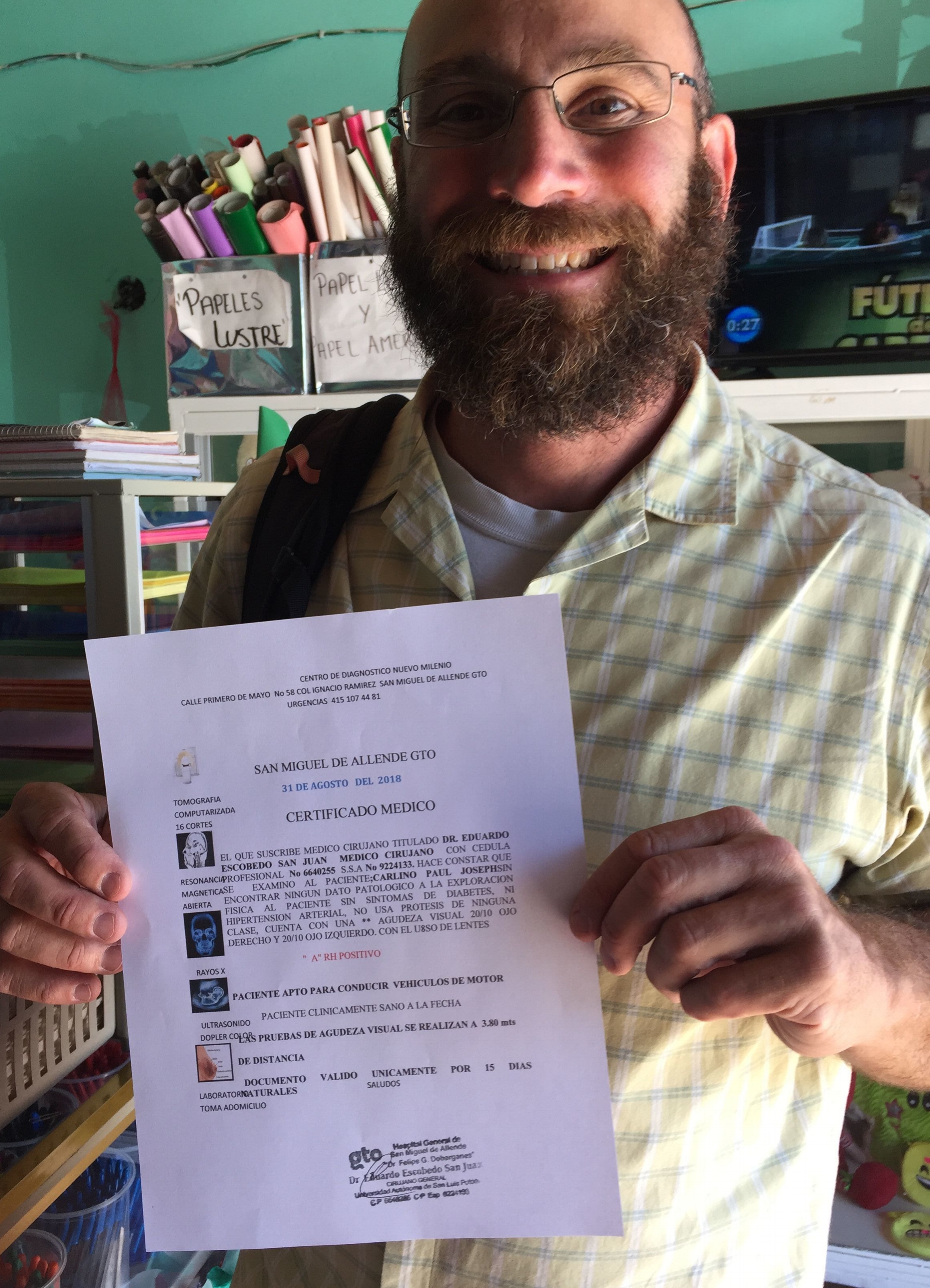 Here I am moments after receiving my medical report. If you can read the small print, it says I am healthy enough to drive.
