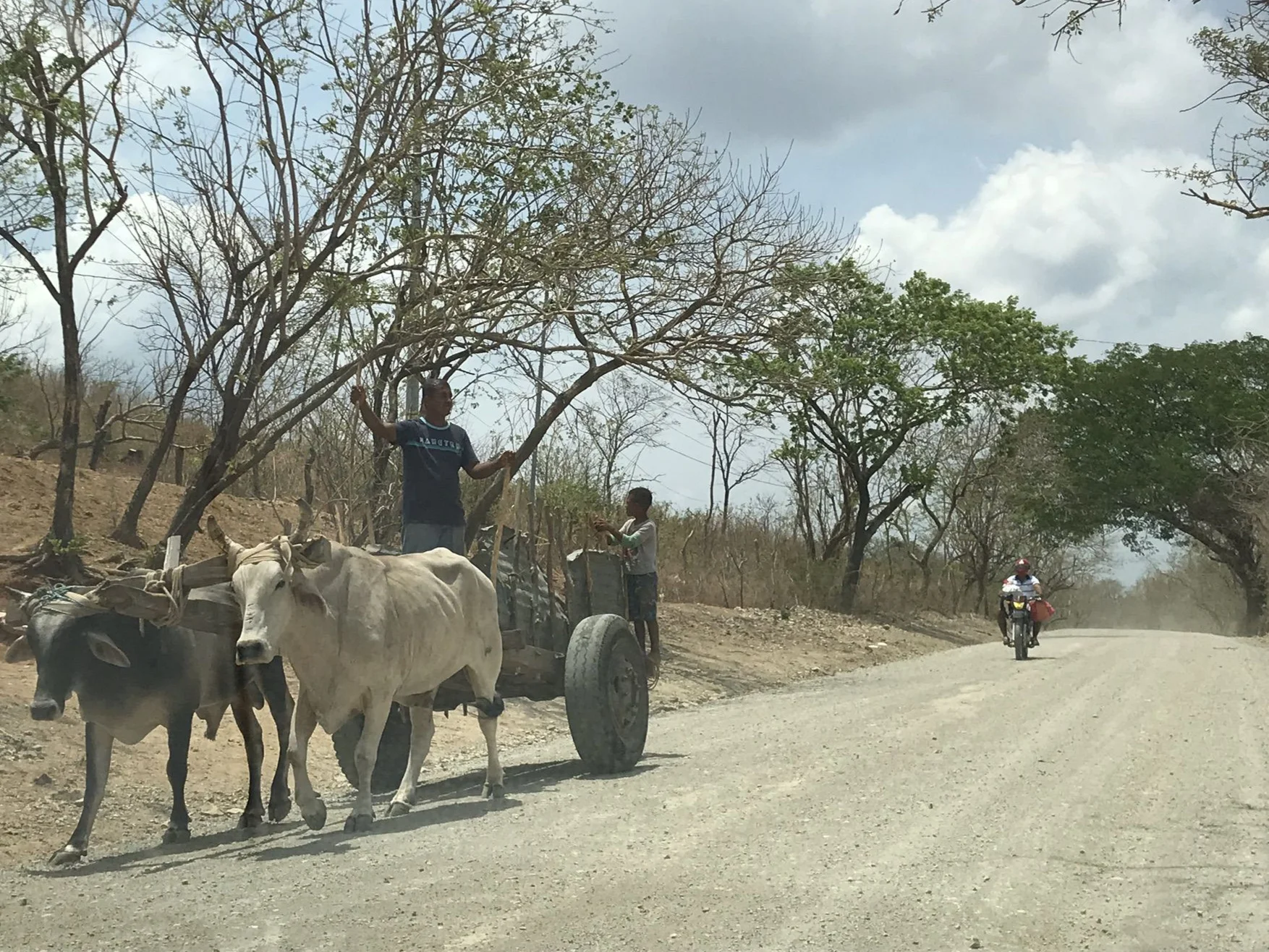 A cow-drawn cart being overtaken by a motorcycle on a dusty road is not an uncommon sight in Nicaragua or any country in Central America.