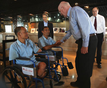DANANG CITY, April 19, 2014 - Senator Patrick Leahy welcomes Phan Van Son (left) and Tran Cong Phuong (right), both are beneficiaries of the Leahy War Victims Funds as Senator Richard Shelby and Mr. Tim Rieser look on.
