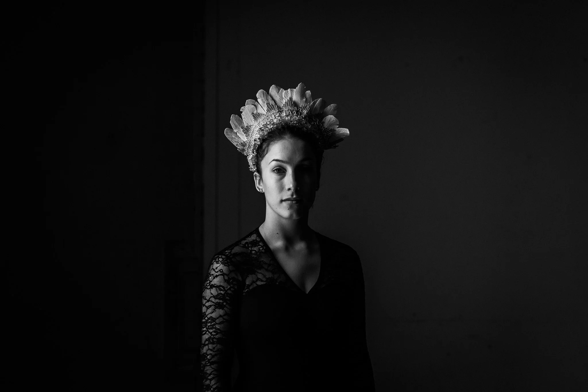 A feather head piece, a dancer, an old, cold building and some snow...