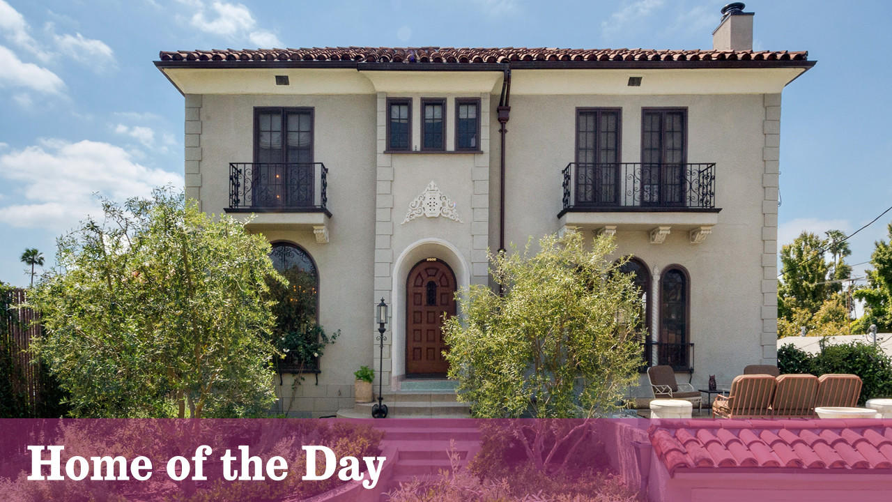 The restored 1927 house features front-facing balconies and ornate details. (Michael McNamara)
