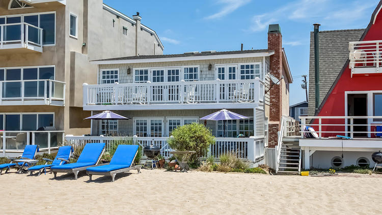 The two-story, East Coast-inspired beach house sits along the sand in the gated Surfside Colony (Linova Photography)