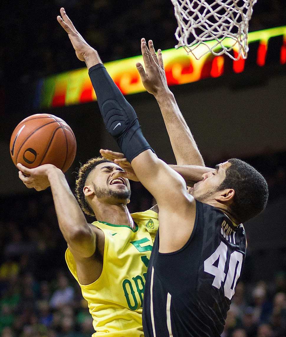   Duck Tyler Dorsey (#5)goes up for a lay up against Colorado Buffalo Josh Scott (#40). The Oregon Ducks defeated the Colorado Buffaloes 76-56.  