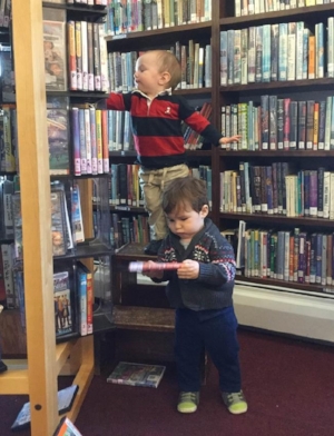 Young Librarians working hard at shelving dvds.