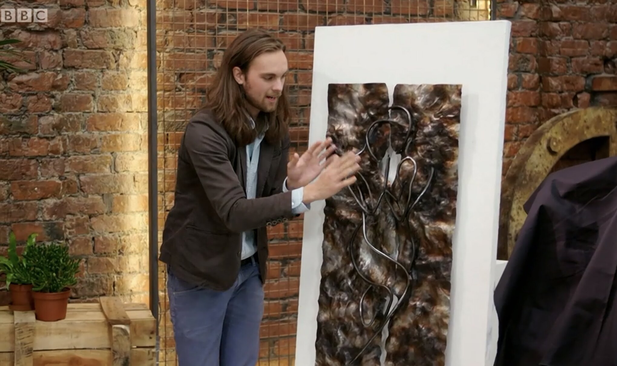 Metal wall sculpture and man