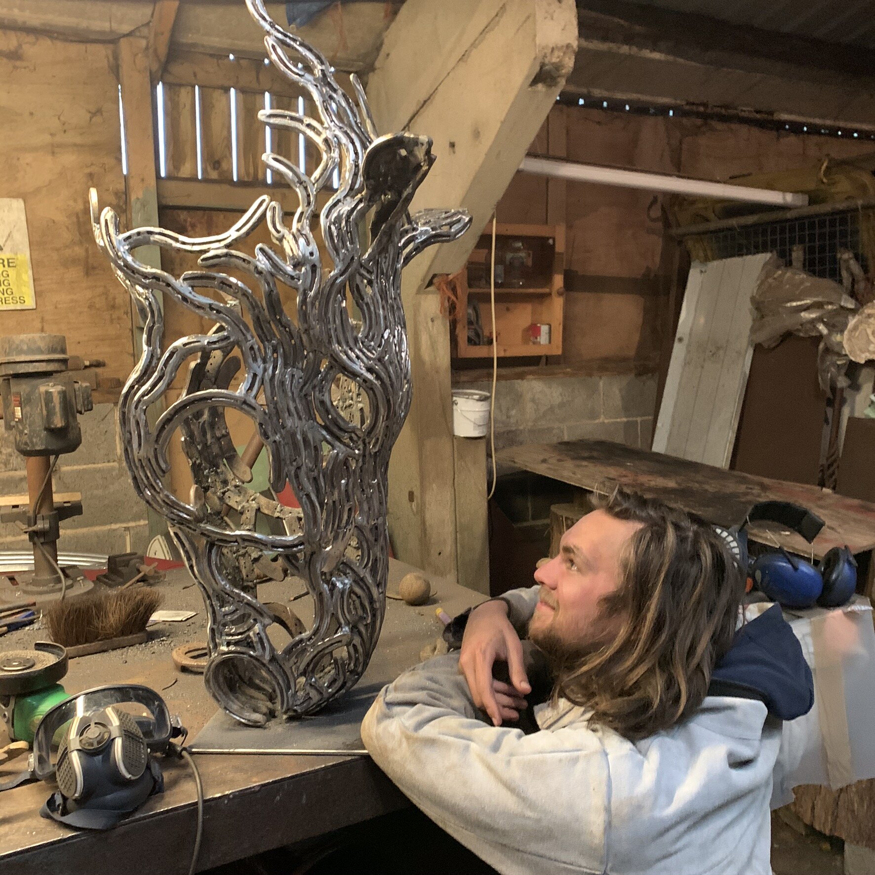 Metal Horse sculpture and Sculptor admiring it.