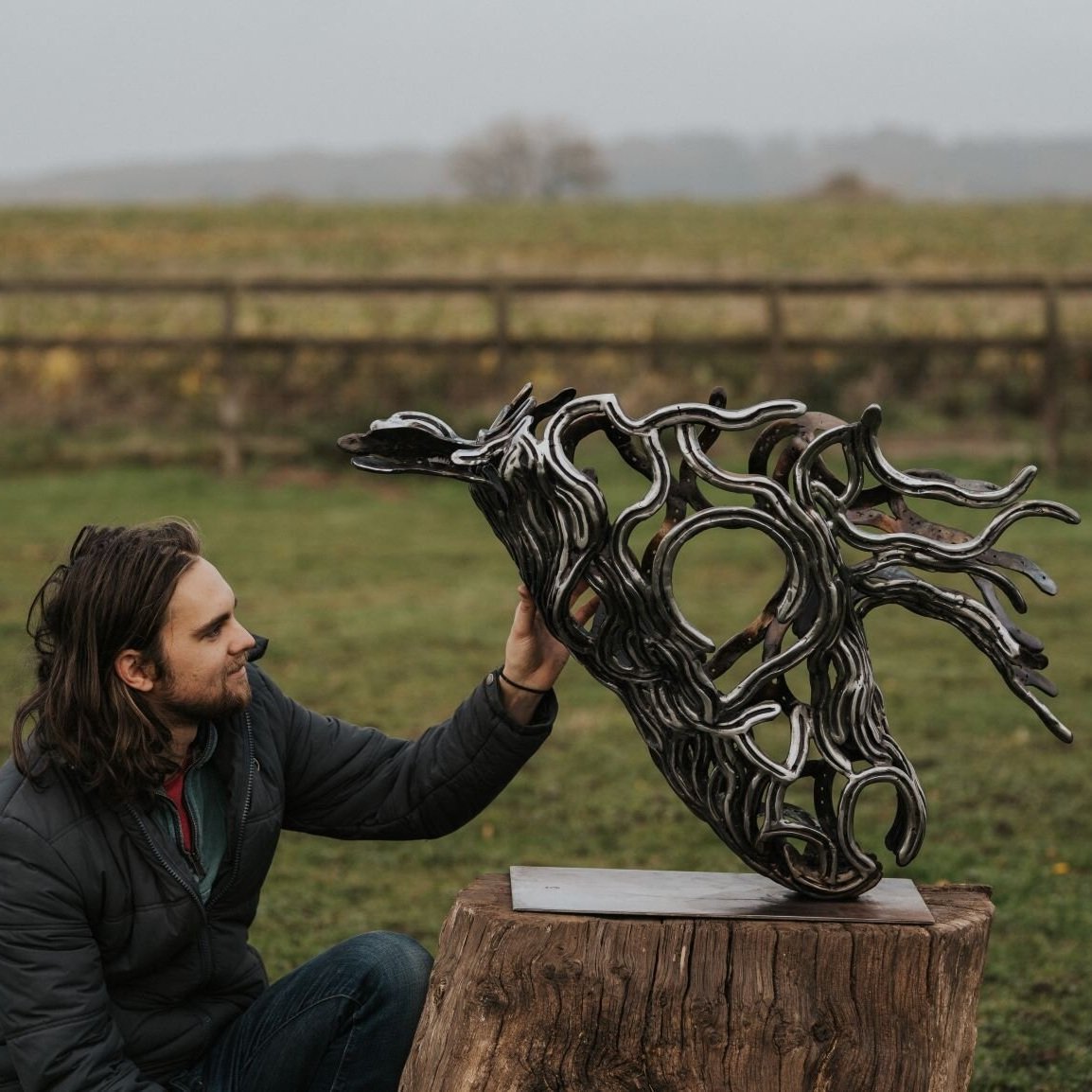 Sculptor and steel horse sculpture