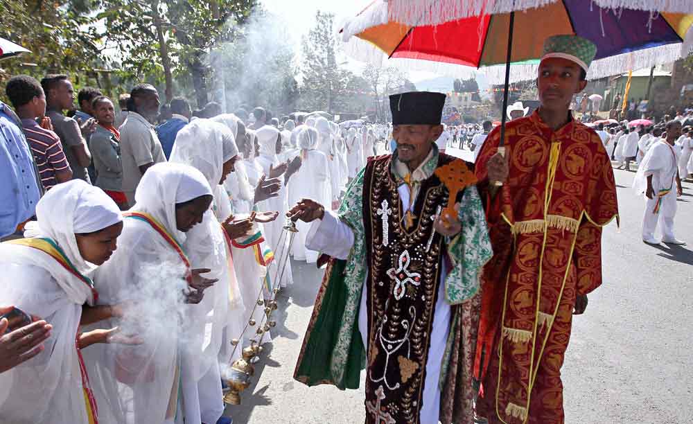 An Ethiopian orthodox priest blesses the faithful with incense during Ethiopia's Timket celebration to commemorate the baptism of Jesus Christ by John the Baptist
