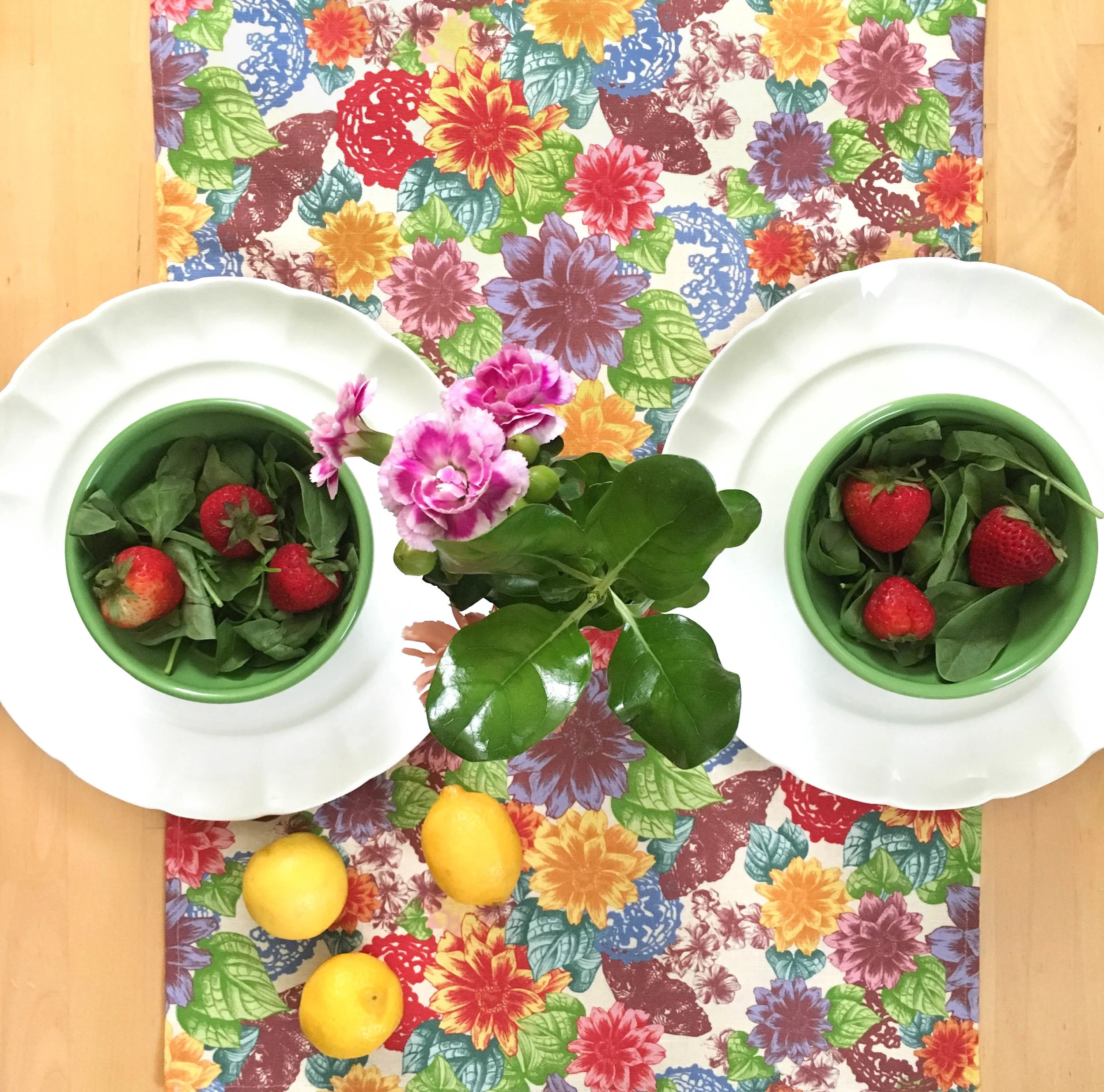 Unique and colorful Zale Table Runner in place setting with flowers, strawberries, and lemons