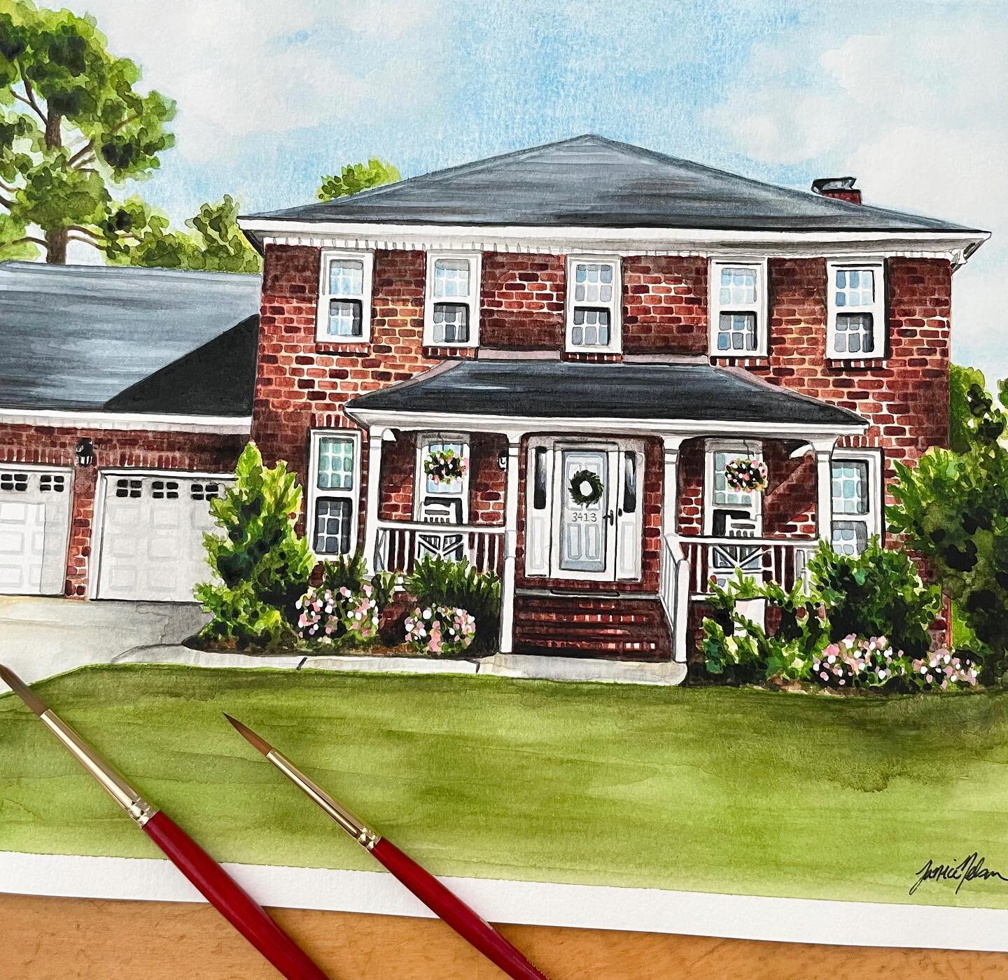 This classic crimson red brick home watercolor is surrounded by lush green landscaping with delicate florals intertwined. I love painting detailed home portraits like this one, and am currently booking for 2024 and beyond!  Email me at info@janicenel