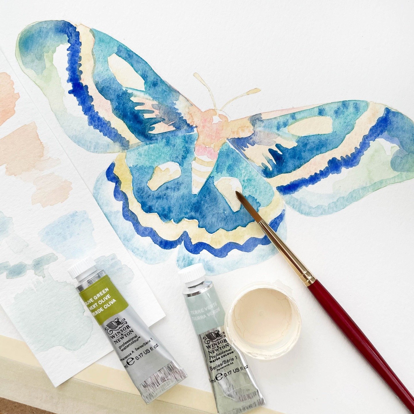 The first watercolor layers meld together to create a foundation to build upon for this ethereal blue moth 🦋