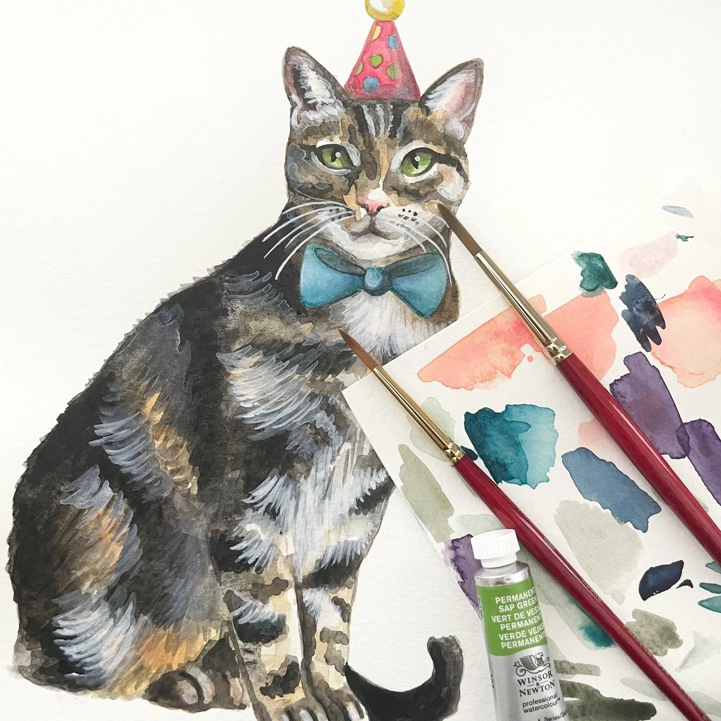 With a polka dot hat and a teal blue bowtie, I would say this cute watercolor cat is definitely ready to party! 🎉 🐈