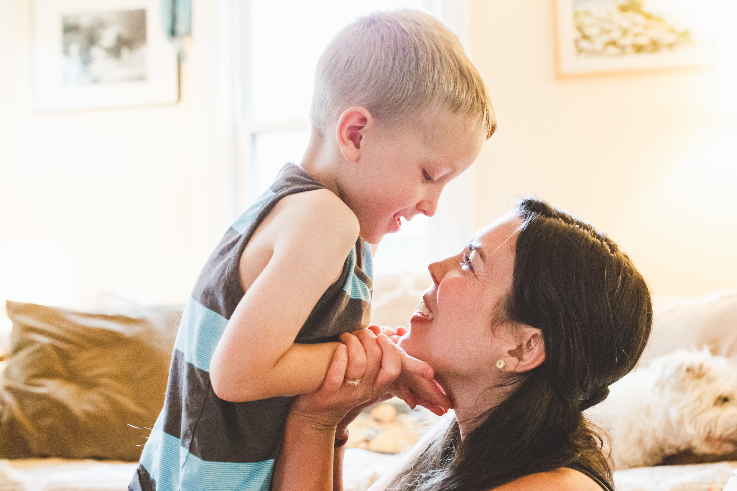 Mother and son gazing into each others faces.