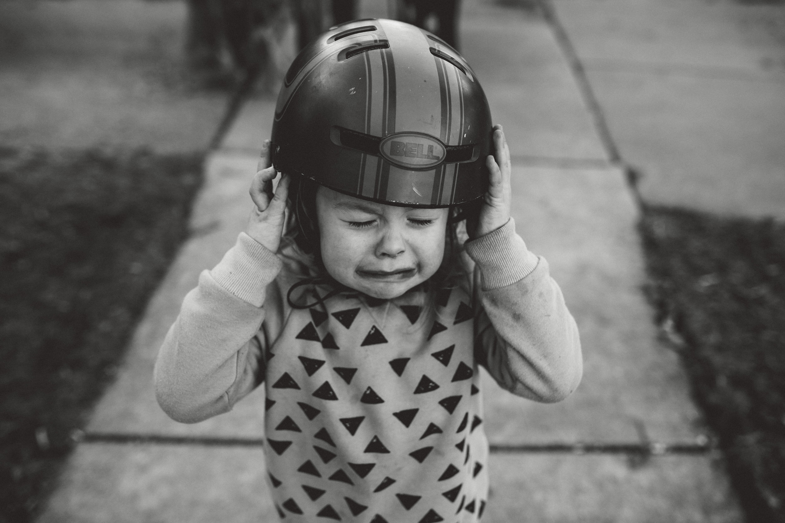 Little boy crying about helmet.