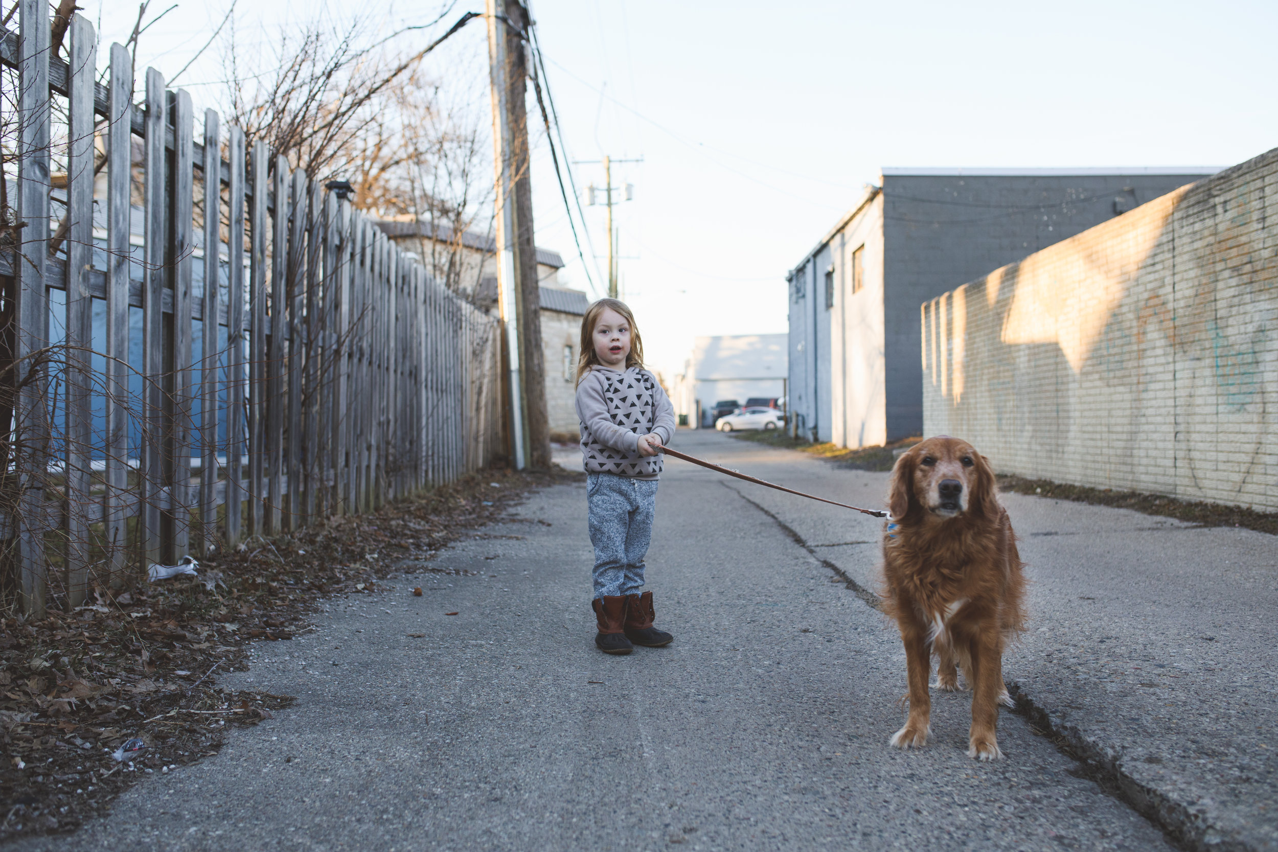 Little boy walking his dog.