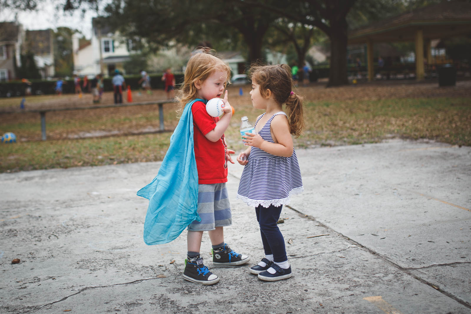 Kids having a conversation on playground.