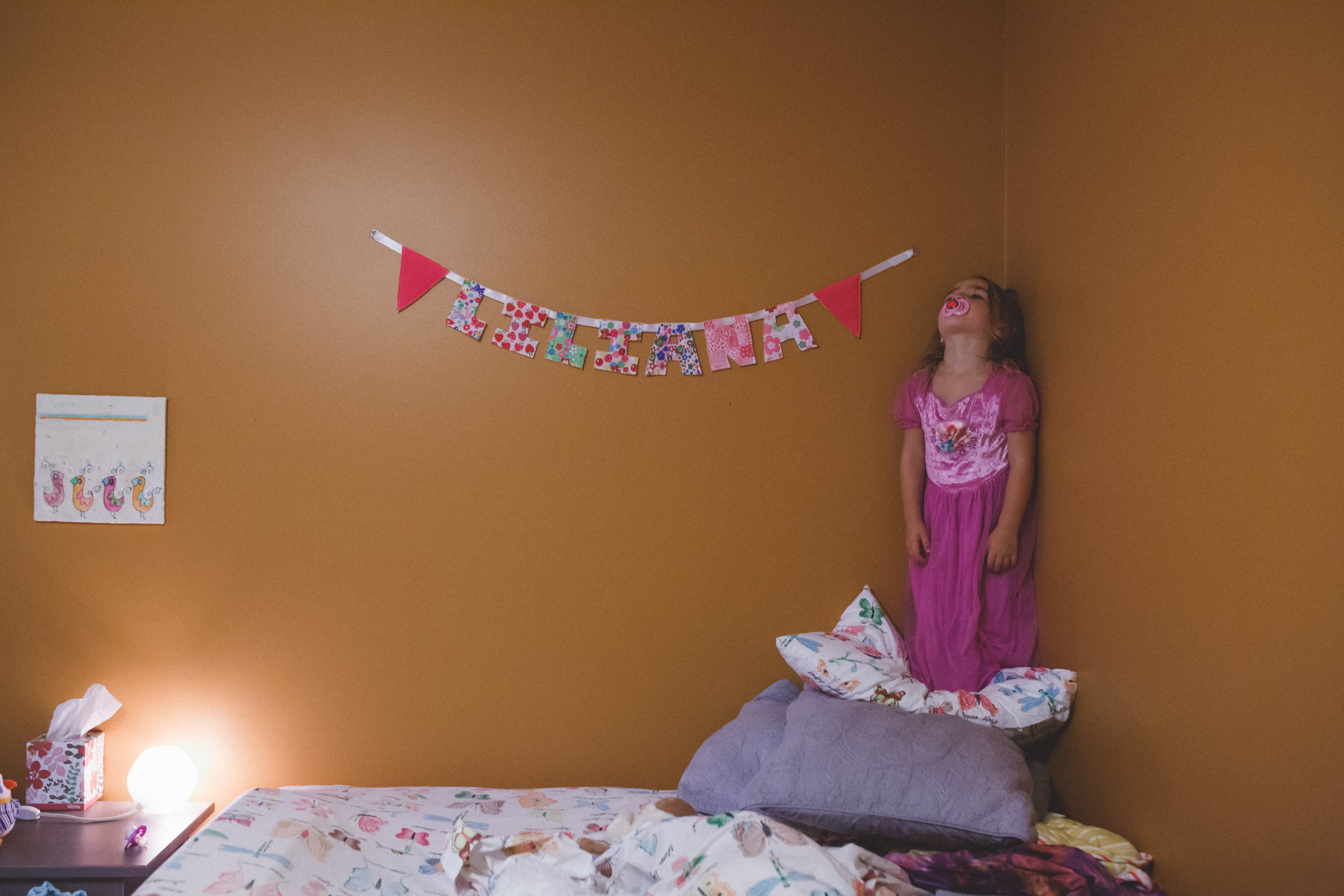 Little girl pouting in corner.