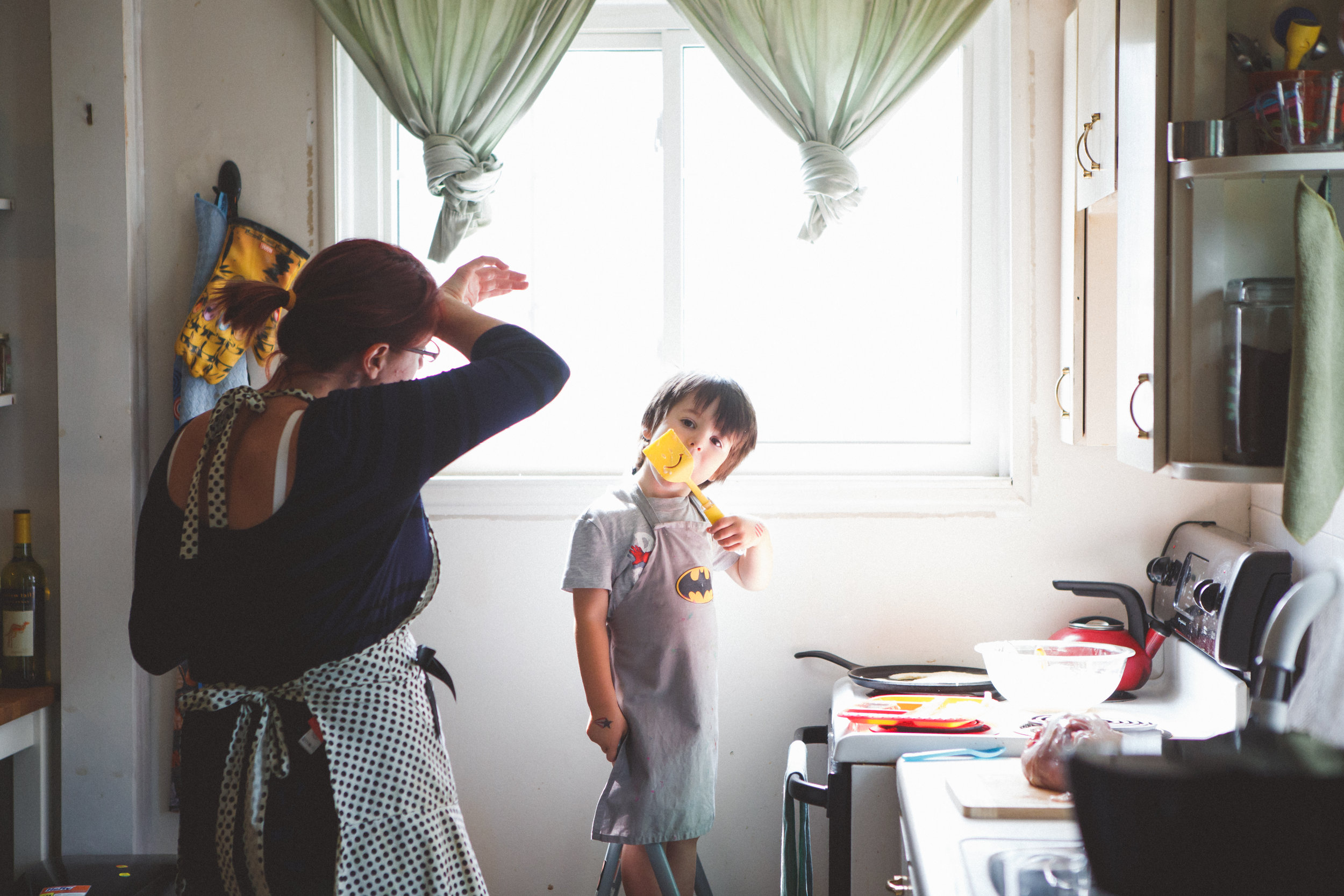 Boy cooking with his mom.