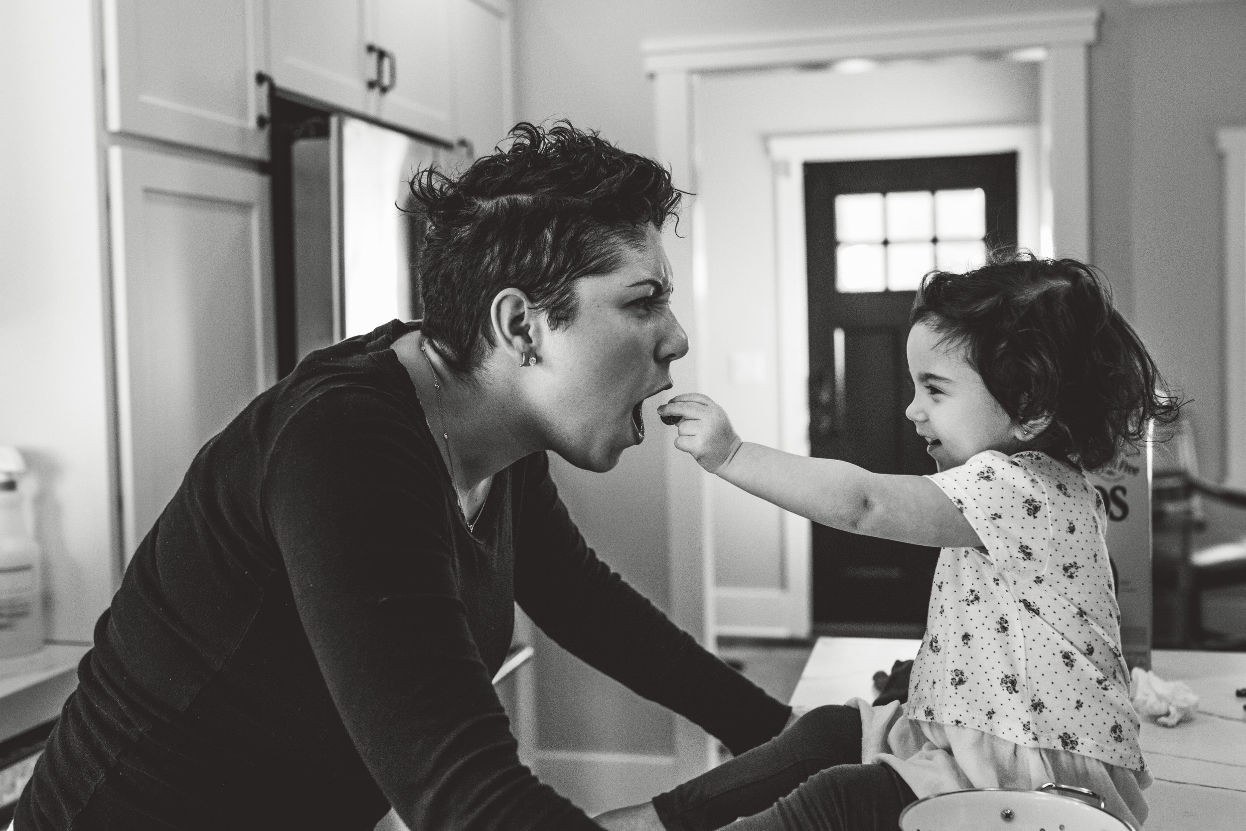 Toddler feeding her mom.