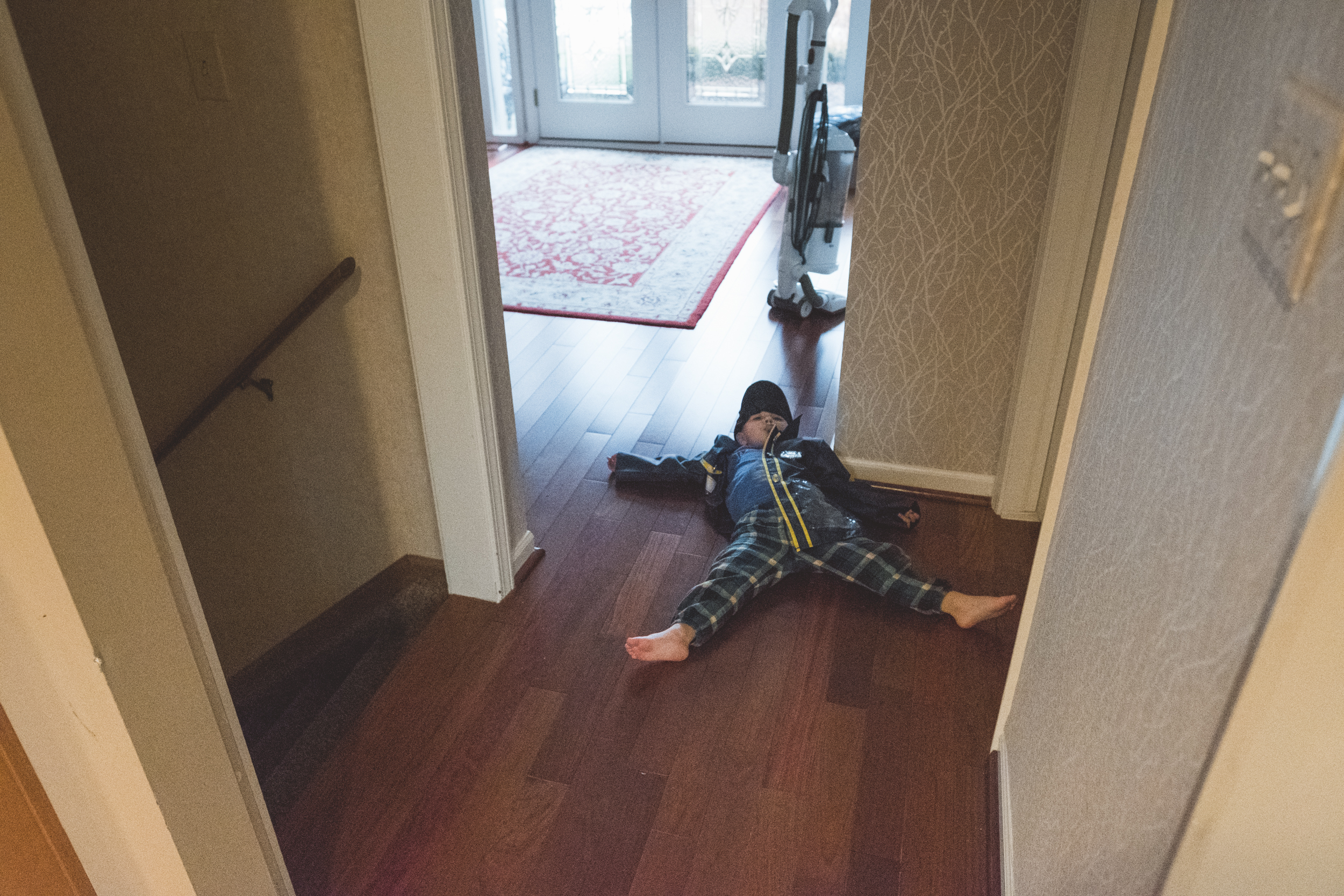 Boy lying on floor. Metro Detroit Ferndale Family Photographer