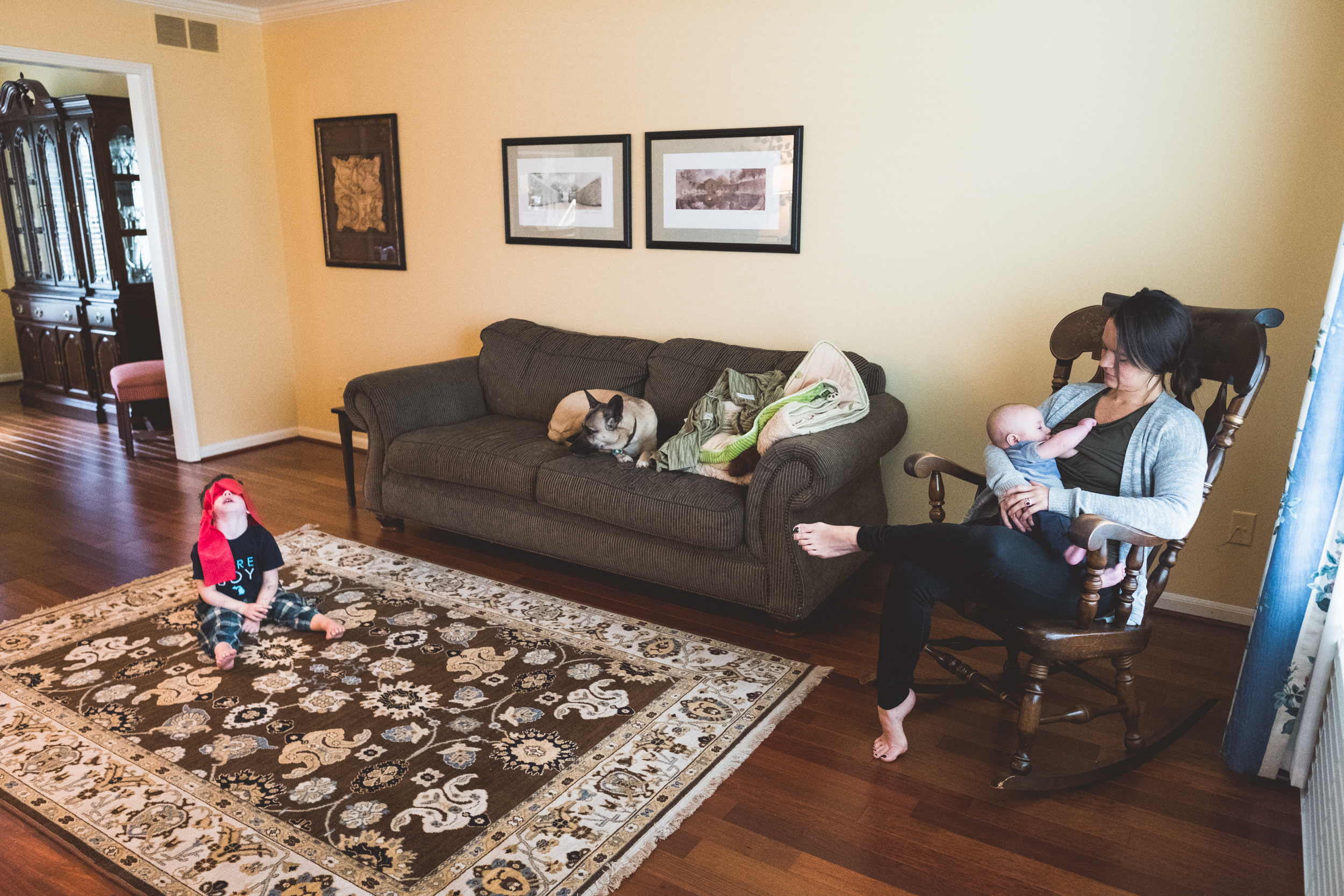 Mom nursing, son bored. Metro Detroit Ferndale Family Photographer.