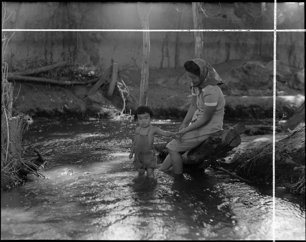  Manzanar Relocation Center, Manzanar, California. Evacuees enjoying the creek which flows along the outer border of this War Relocation Authority center. 