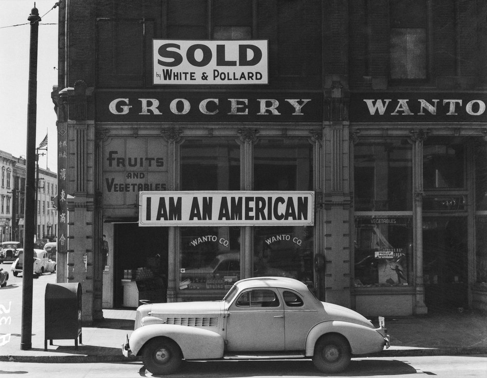    PRINT AVAILABLE   Oakland, Calif., Mar. 1942. A large sign reading "I am an American" placed in the window of a store, at 13th and Franklin streets, on December 8, the day after Pearl Harbor. The store was closed following orders to persons of Jap