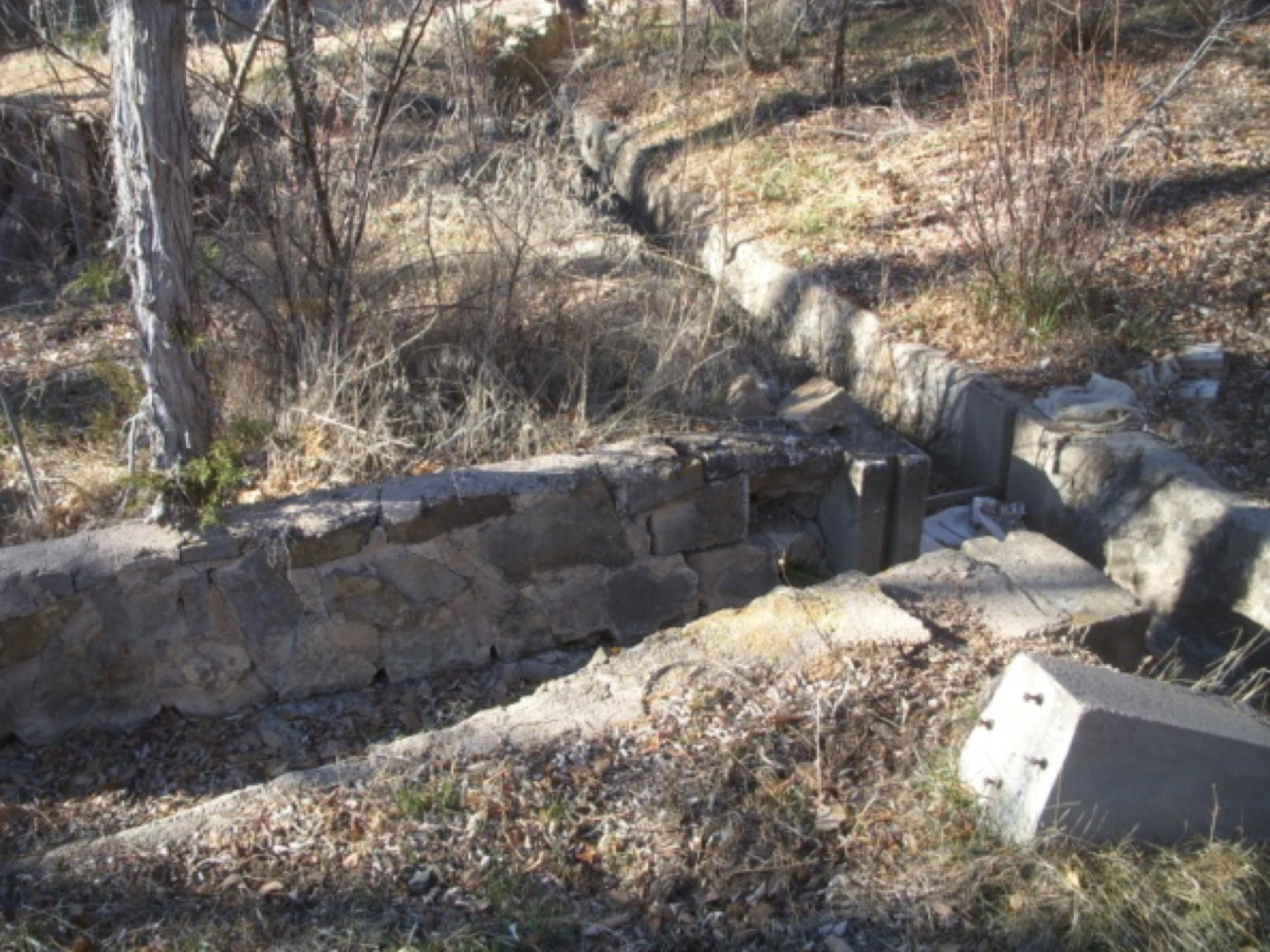  Stonework lining the acequia and entrance to the current lateral at 9 Camino Pequeño.   photo by the Deborah and Jon Lawrence   