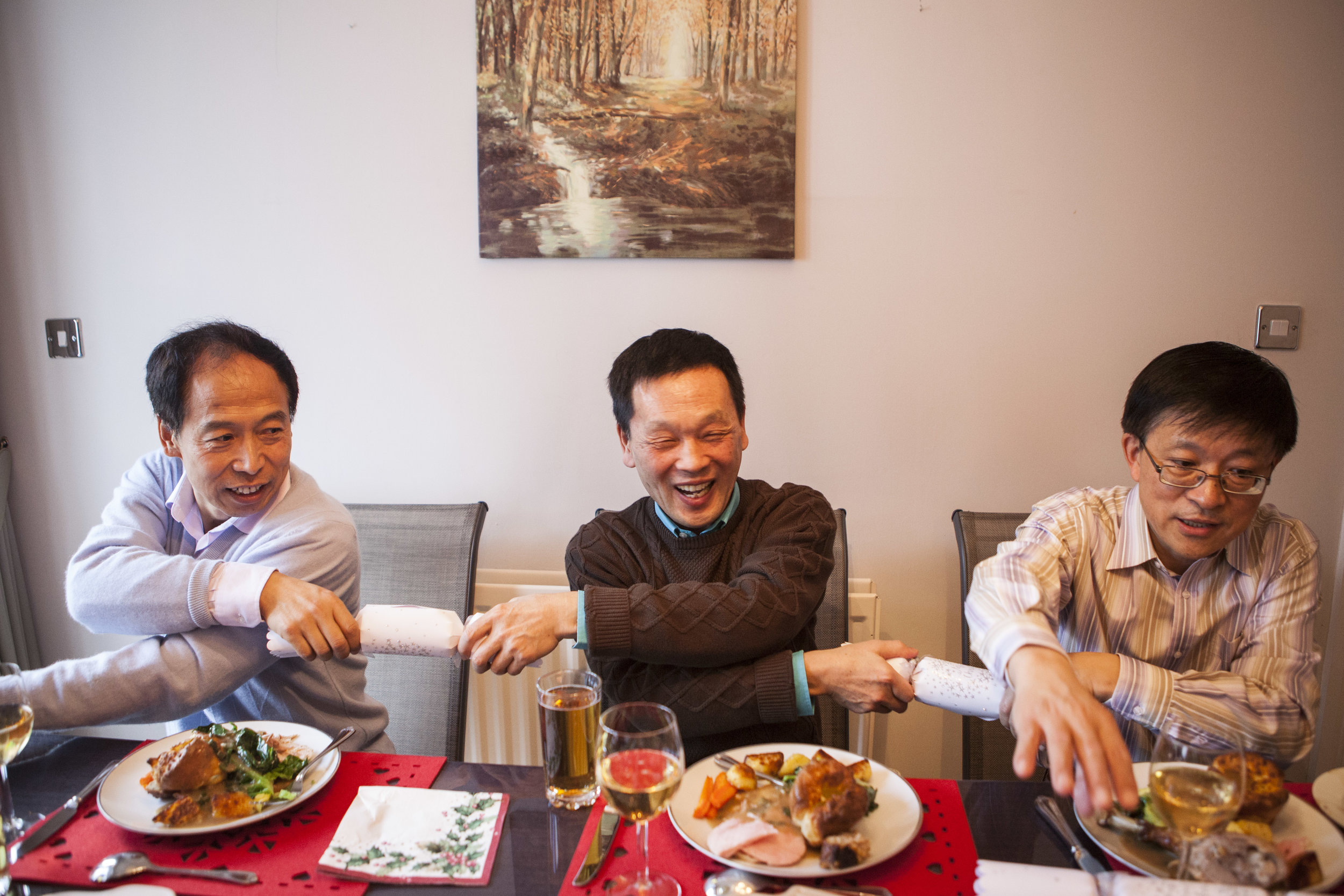  Three engineers pull crackers at Professor Dong’s (right) son’s new house.&nbsp; 