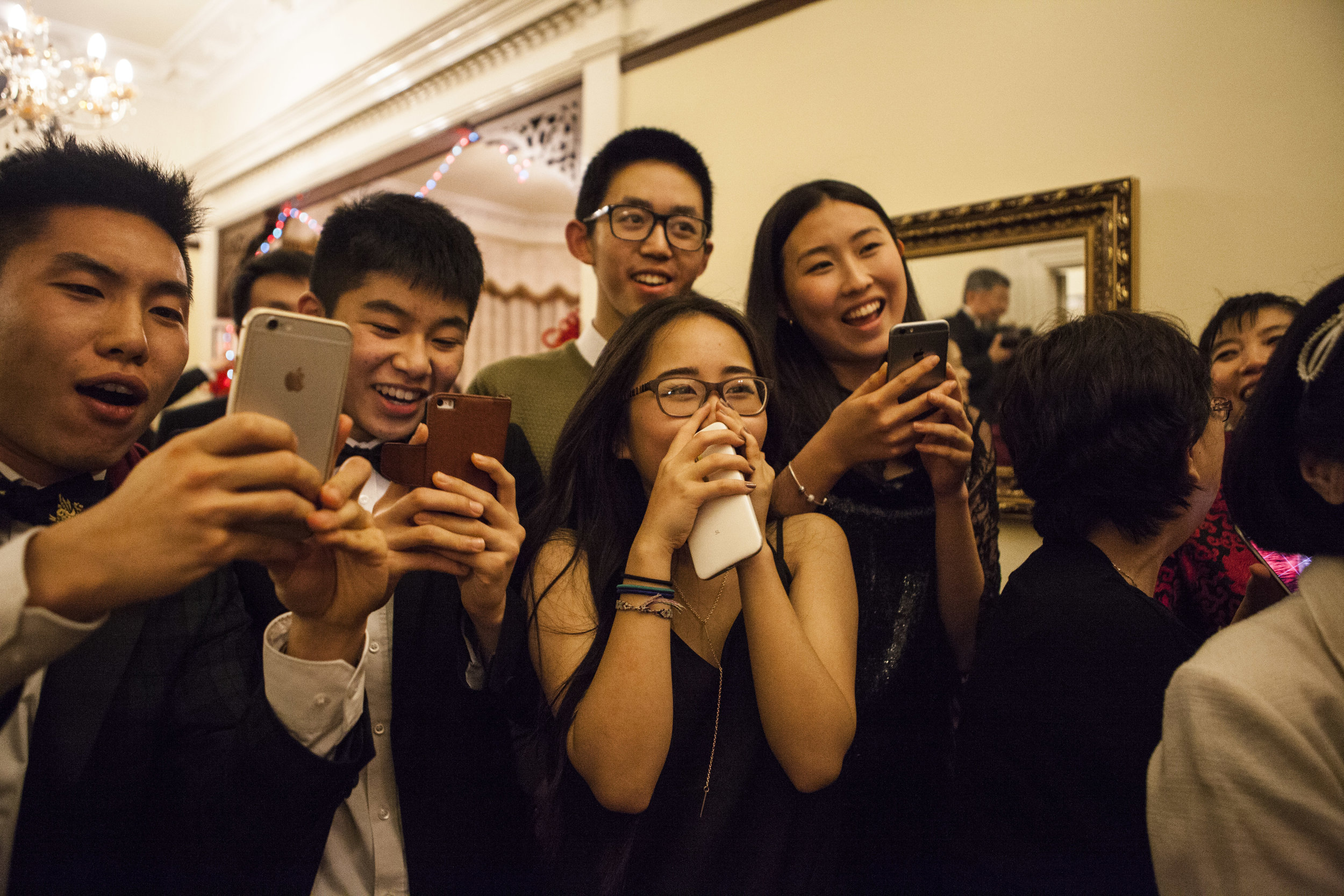  Second generation Chinese youth react to their parents’ fancy dress costumes as the procession comes down the stairs. 