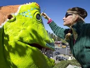 Cheryl Latimer revamping the iconic T-Rex at Peter Pan Mini Golf on Barton Springs Road in Austin Texas