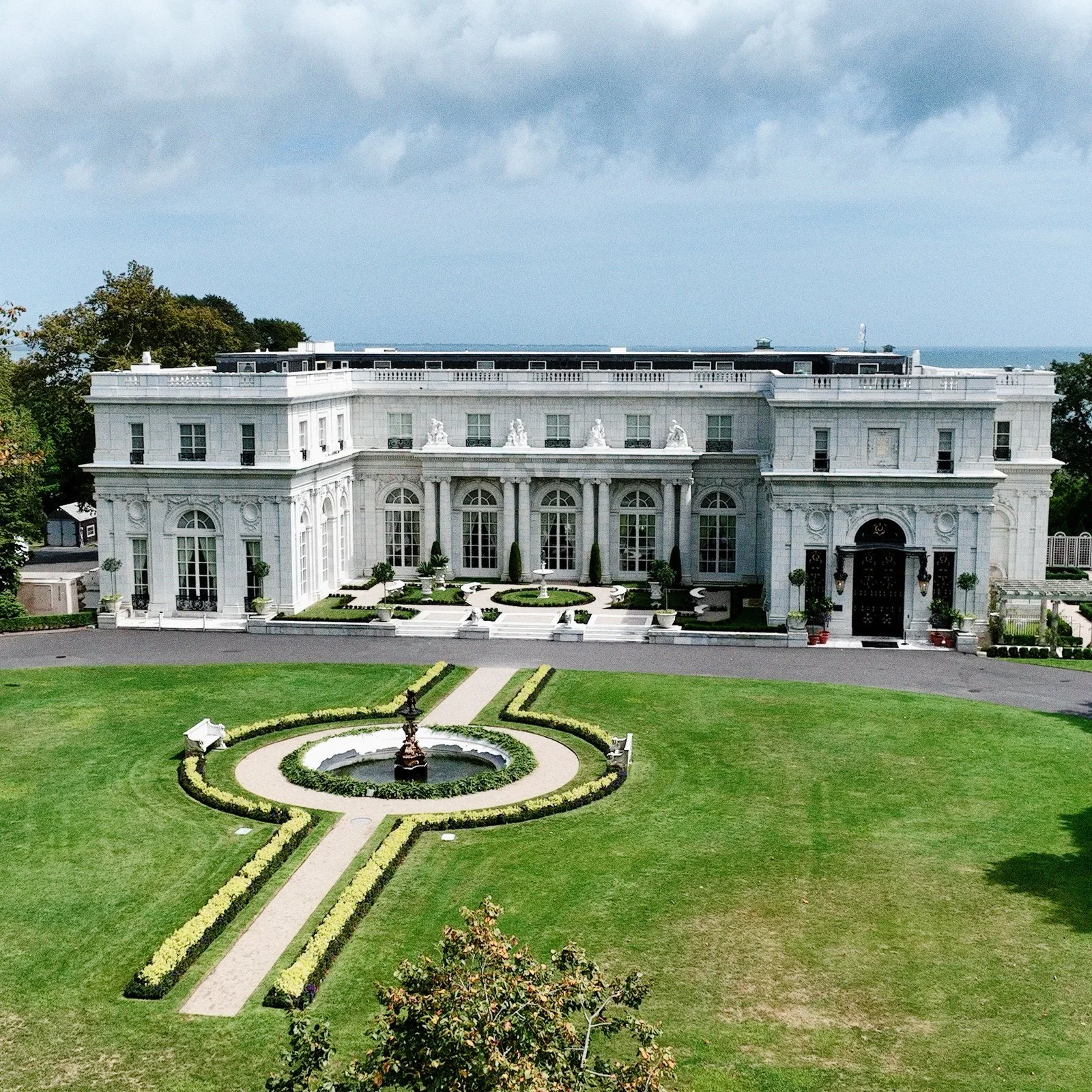 Rosecliff Mansion seen from the air, its white facade above the fountain and clipped parterre on the front lawn, Newport, Rhode Island