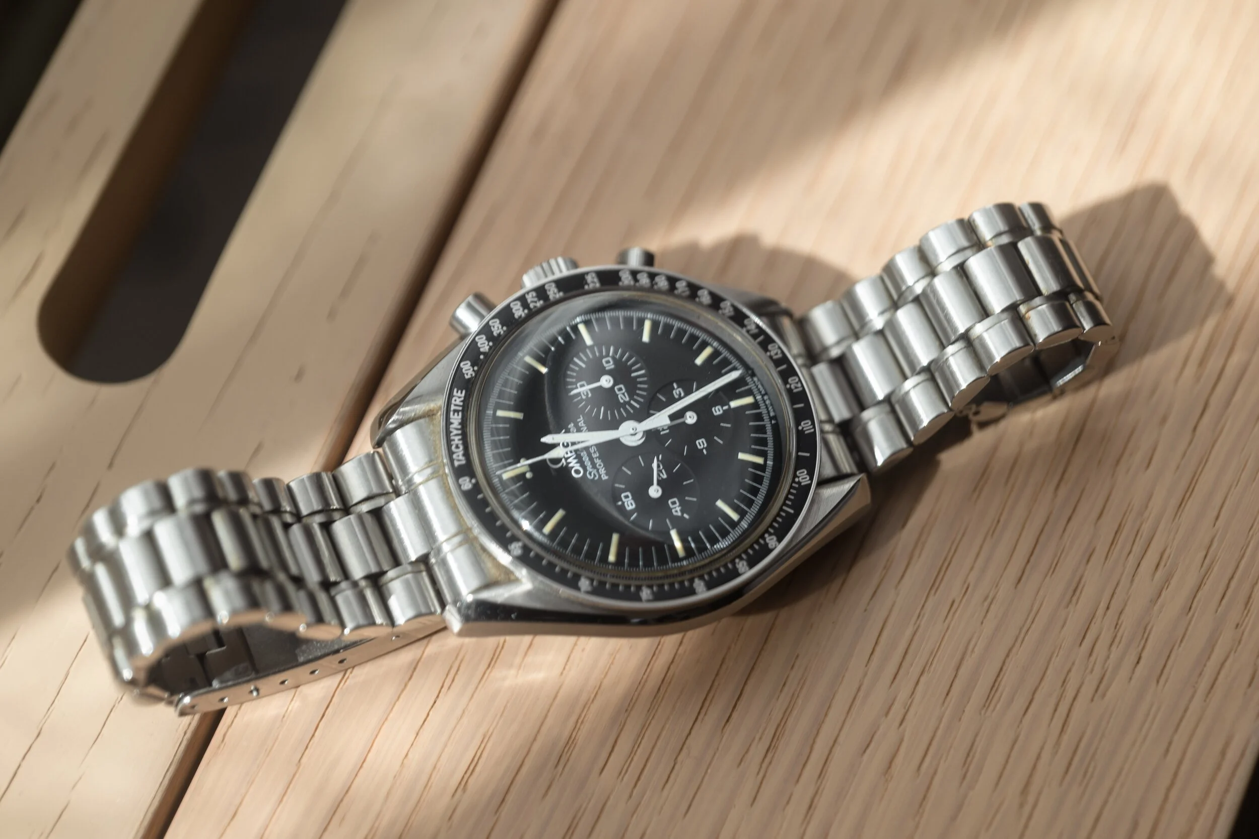 A watch resting on a wood surface, Newport, Rhode Island.