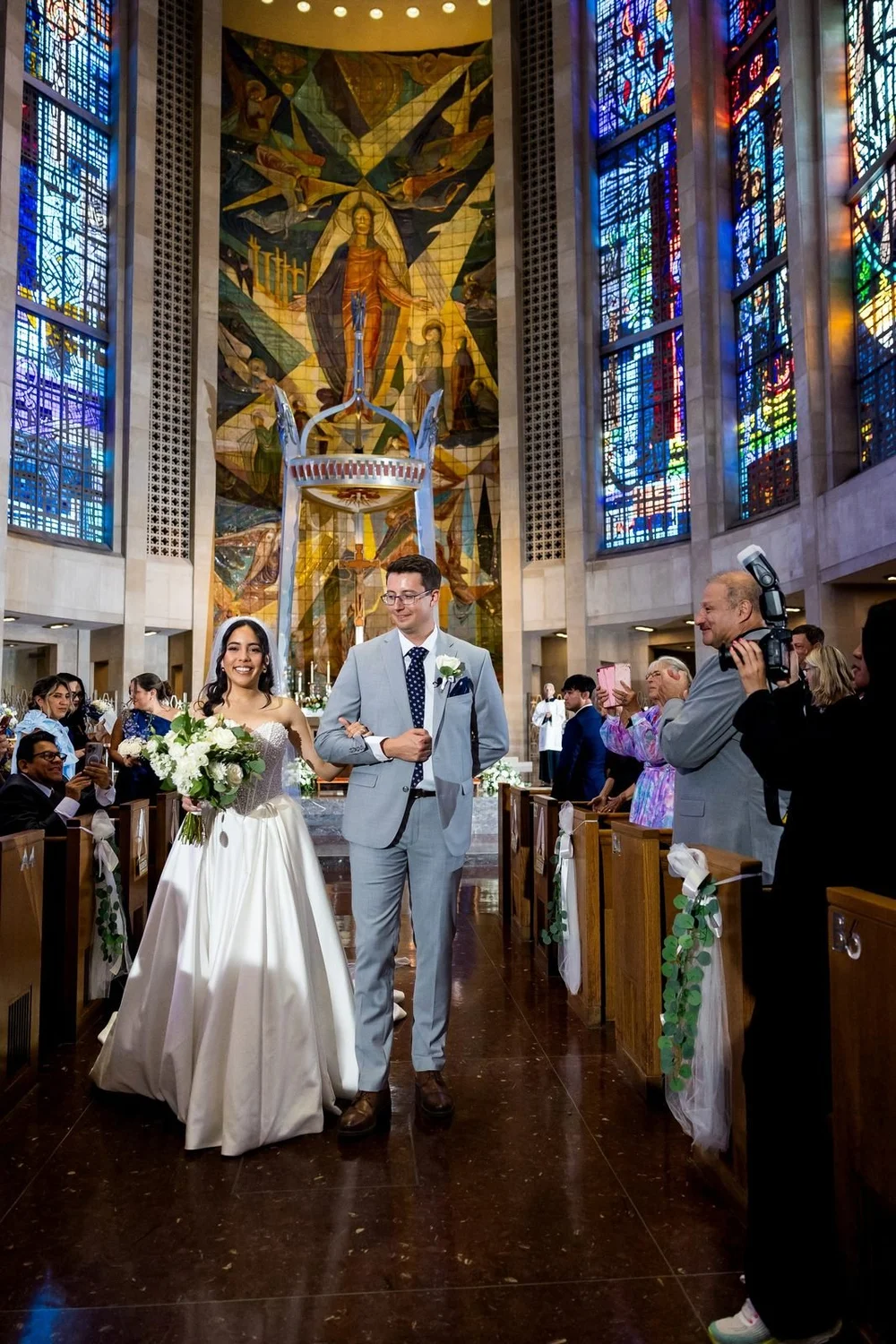 The Society Room of Hartford wedding videographer, Hartford, CT â€” newlyweds walking up the church aisle after their vows