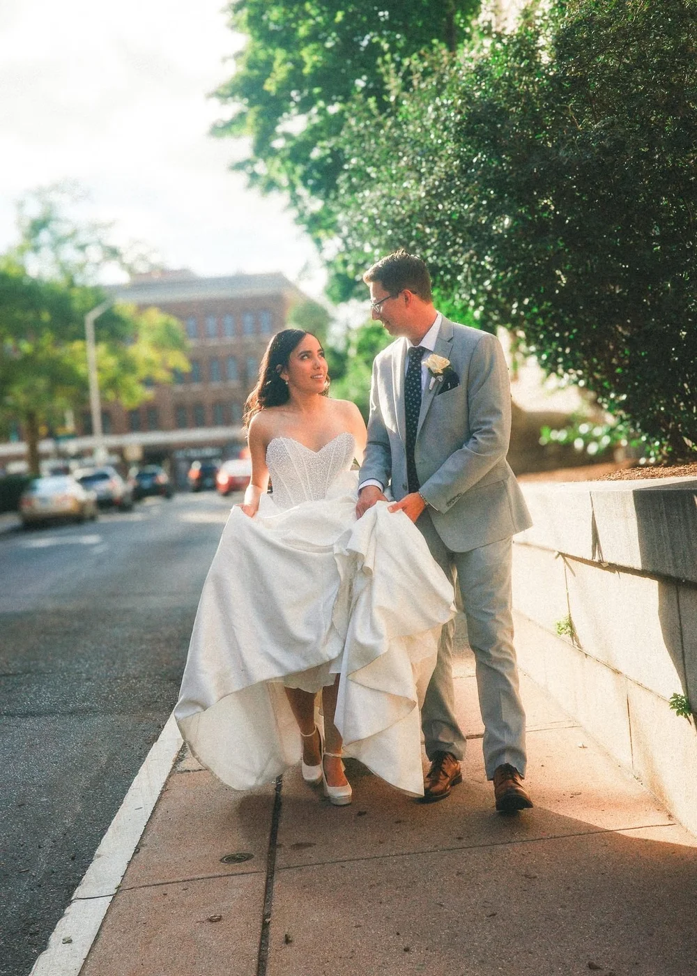 The Society Room of Hartford wedding photographer, Hartford, CT â€” bride and groom strolling a tree-lined city street at golden hour