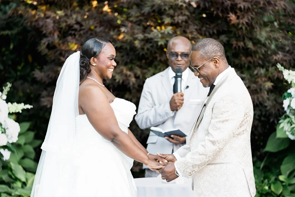 Avenir wedding photographer, Walpole, MA — bride and groom exchanging vows beneath the white garden arbor
