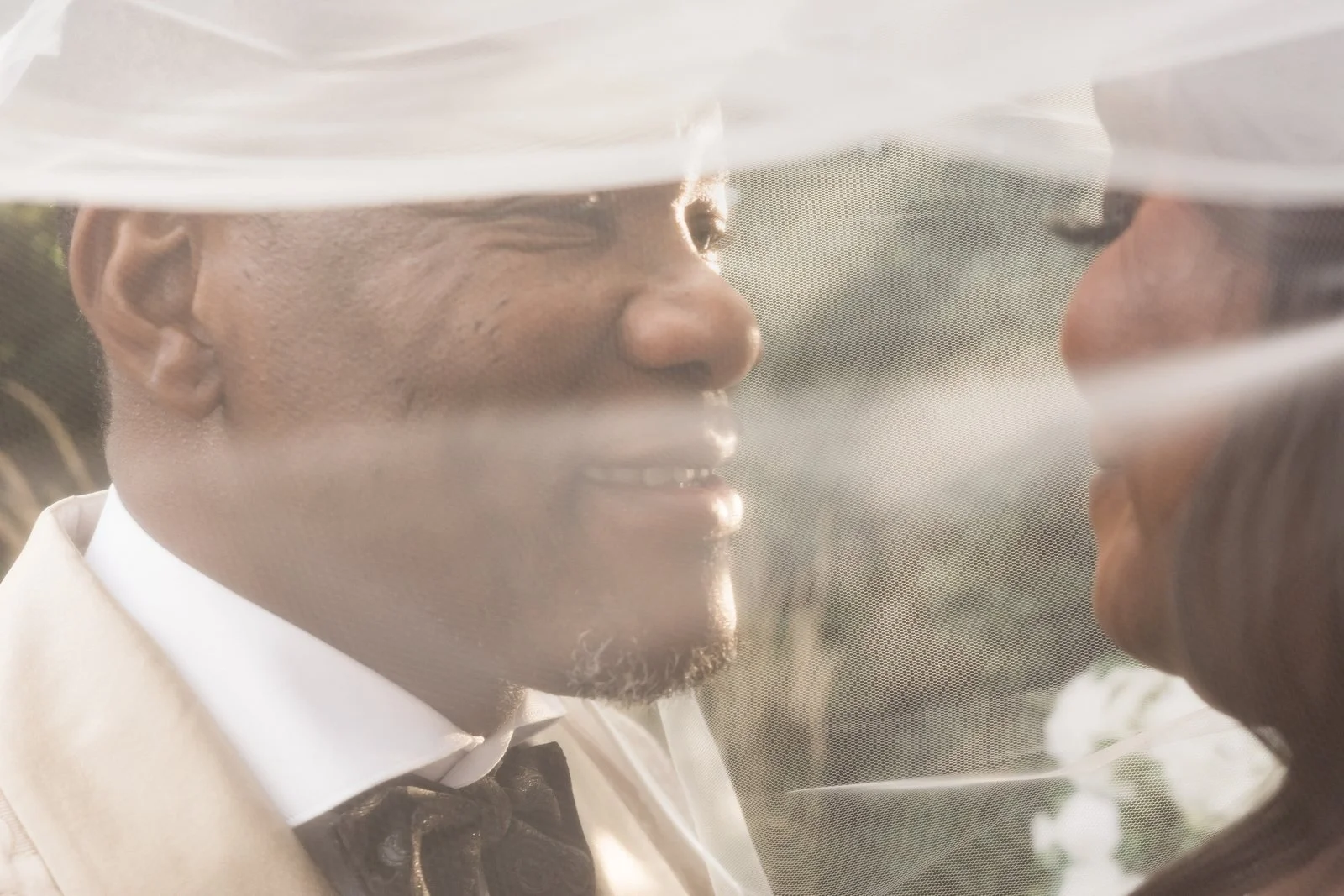 Avenir wedding videographer, Walpole, MA — close veil-covered kiss between the bride and groom after the ceremony